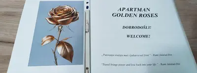 a book about garden roses with a picture of a flower at Golden Roses Apartment in Niš