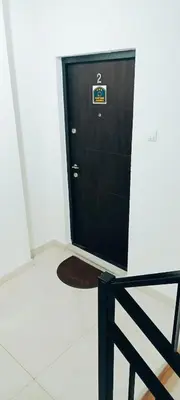 a black door with a sign on it in a room at Golden Roses Apartment in Niš