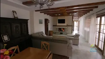 a living room with a couch and a fireplace at Etno selo Katunija in Katun