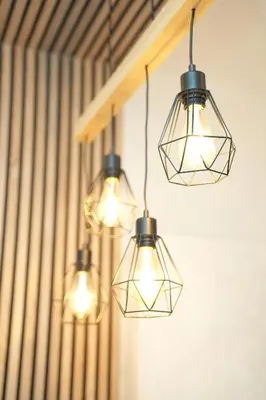 a group of lights hanging from a wall at Residence Hill - Planinski Kutak in Kopaonik