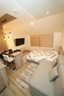 a bedroom with a bed and a desk with a computer at Residence Hill - Planinski Kutak in Kopaonik
