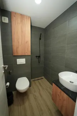 a bathroom with a white toilet and a sink at Residence Hill - Planinski Kutak in Kopaonik