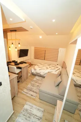 a living room with a bed and a desk at Residence Hill - Planinski Kutak in Kopaonik
