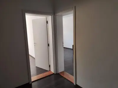 an empty room with two doors and a mirror at Sudent Rooms in Niš