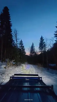 a car is driving down a snow covered road at Planinska kuća Arbinje in Dojkinci