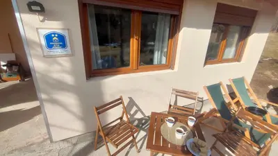 a group of chairs sitting outside of a building at Planinska kuća Arbinje in Dojkinci