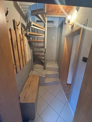 a staircase in a room with a wooden bench at Vlasinska Bajka in Vlasina Rid