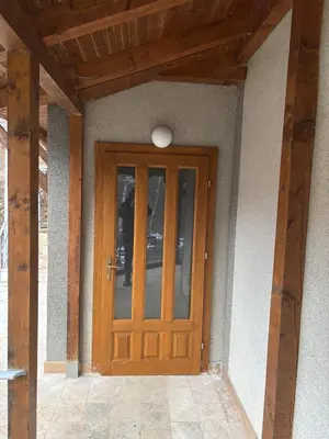 a wooden door of a house with a wooden ceiling at Vlasinska Bajka in Vlasina Rid