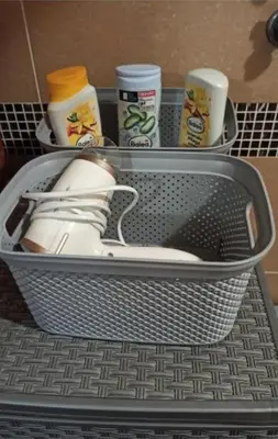 a metal container with a pair of shoes in a drawer at Apolon Spa Lux in Vrnjačka Banja