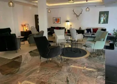 a lobby with chairs and tables and a living room at Apolon Spa Lux in Vrnjačka Banja