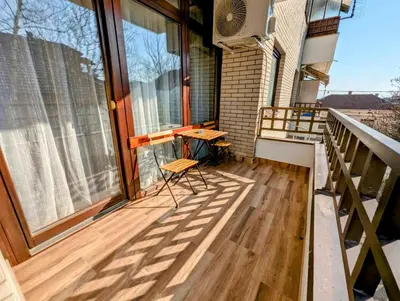 a balcony with a table and chairs on it at Apartman Karingtonka free parking in Vranje