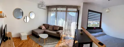 a living room with a couch and a window at Apartman Karingtonka free parking in Vranje