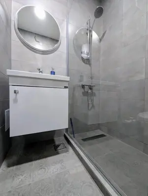 a bathroom with a shower and a sink and a mirror at Apartman Karingtonka free parking in Vranje