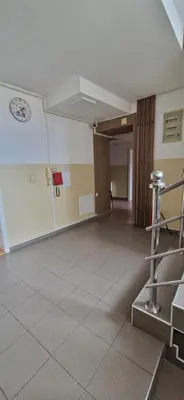 an empty room with a tile floor and a wall at Plavi Dom in Ćuprija
