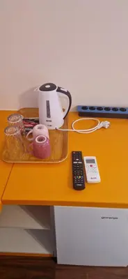 a table with a coffee pot and a remote control at Plavi Dom in Ćuprija