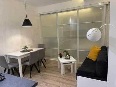 a living room with a table and a couch at Tontic Lux Residence Hill 54 in Kopaonik