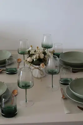 a table topped with wine glasses and a centerpiece at Apartman TAUNUS in Kopaonik