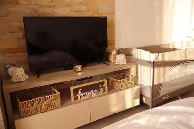 a flat screen tv sitting on top of a entertainment center at Apartman TAUNUS in Kopaonik