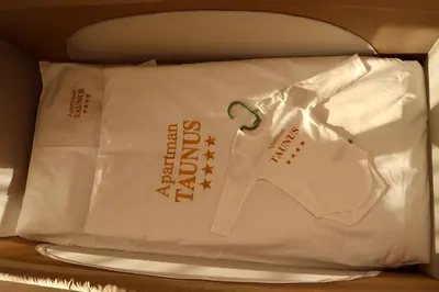 a pillow in a bag sitting on a shelf at Apartman TAUNUS in Kopaonik