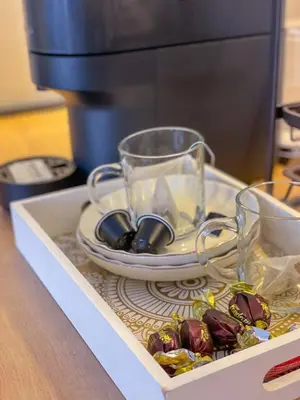 a tray with glasses and a plate and a coffee maker at Zlatkovic Family in Pirot
