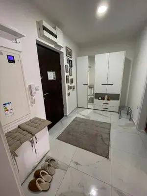 a large room with a hallway with shoes on the floor at Zlatkovic Family in Pirot