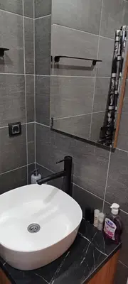 a bathroom with a white sink and a mirror at Residence Hill apartment TammyMatty in Kopaonik
