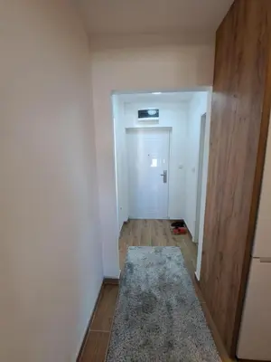 an empty hallway with a door and a rug at Apartman Tea in Niš