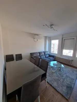 a living room with a couch and a table at Apartman Tea in Niš