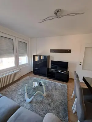 a living room with a couch and a table at Apartman Tea in Niš