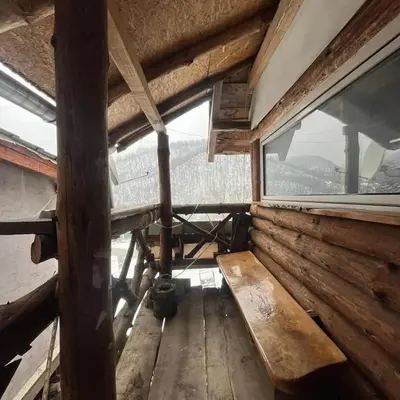 an inside view of a cabin with a large window at Apartmani Manojlović in Crni Vrh