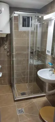 a bathroom with a shower and a sink at Apartman Aki in Niš
