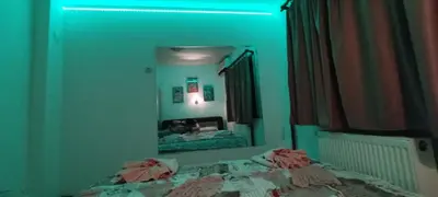a bedroom with a bed in front of a mirror at Apartman Aki in Niš