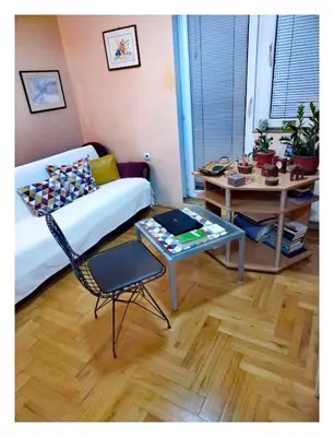 a living room with a couch and a table at Origami in Niš