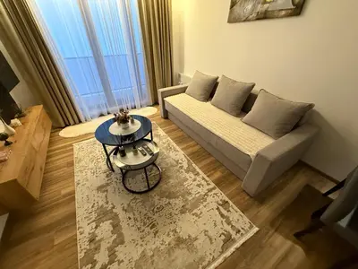 a living room with a couch and a table at Gold Elegant & Spa Kop in Kopaonik