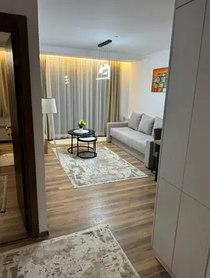 a living room with a couch and a table at Gold Elegant & Spa Kop in Kopaonik