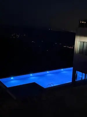 a view of a swimming pool at night at Gold Elegant & Spa Kop in Kopaonik