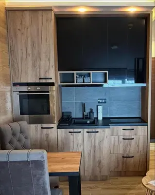 a kitchen with a sink and a stove top oven at Apartmani Mir Kopaonik in Kopaonik