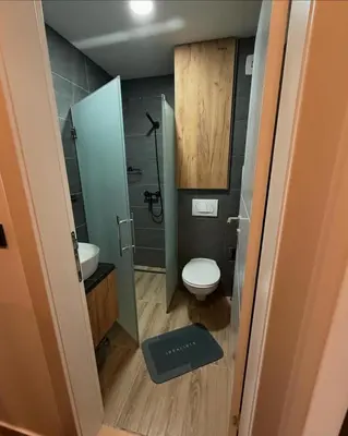 a small bathroom with a toilet and a sink at Apartmani Mir Kopaonik in Kopaonik