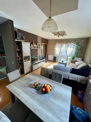 a living room with a table and a couch at Kuća Vujović in Niš