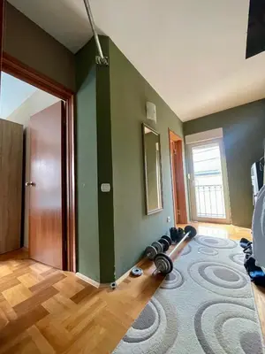 a living room with a room with a gym equipment on the floor at Kuća Vujović in Niš