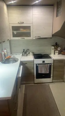 a small kitchen with a sink and a stove at Kuća Vujović in Niš