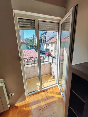 a room with a balcony with sliding glass doors at Kuća Vujović in Niš