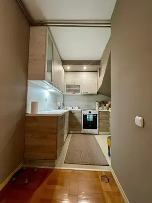 a small kitchen with a sink and a stove at Kuća Vujović in Niš
