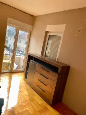 a kitchen with a wooden dresser in a room at Kuća Vujović in Niš