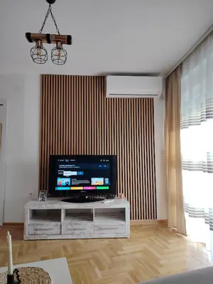 a living room with a large flat screen tv at Apartman Bonbon in Vrnjačka Banja