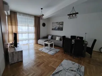 a living room with a couch and a table at Apartman Bonbon in Vrnjačka Banja