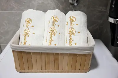 two towels in a wooden basket on a counter at Apartman Babić Lux in Vrnjačka Banja