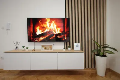 a tv sitting on top of a white cabinet with a fire at Apartman Babić Lux in Vrnjačka Banja