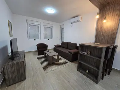 a living room with a couch and a table at Best apartments 2 in Paraćin