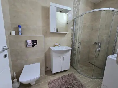 a bathroom with a shower and a toilet and a sink at Best apartments 2 in Paraćin